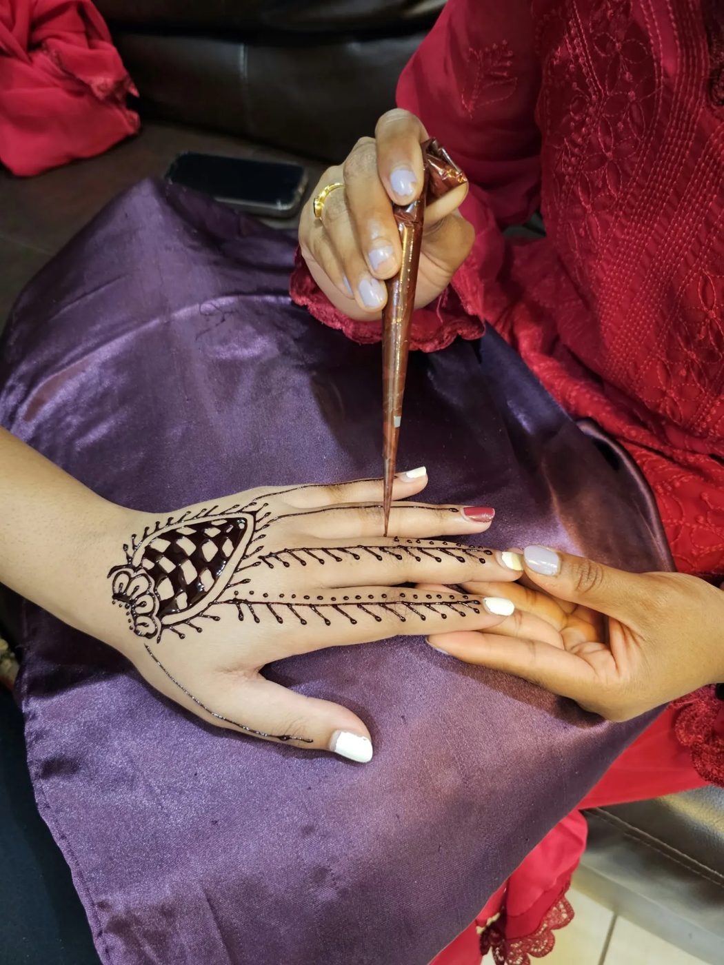 Applying henna